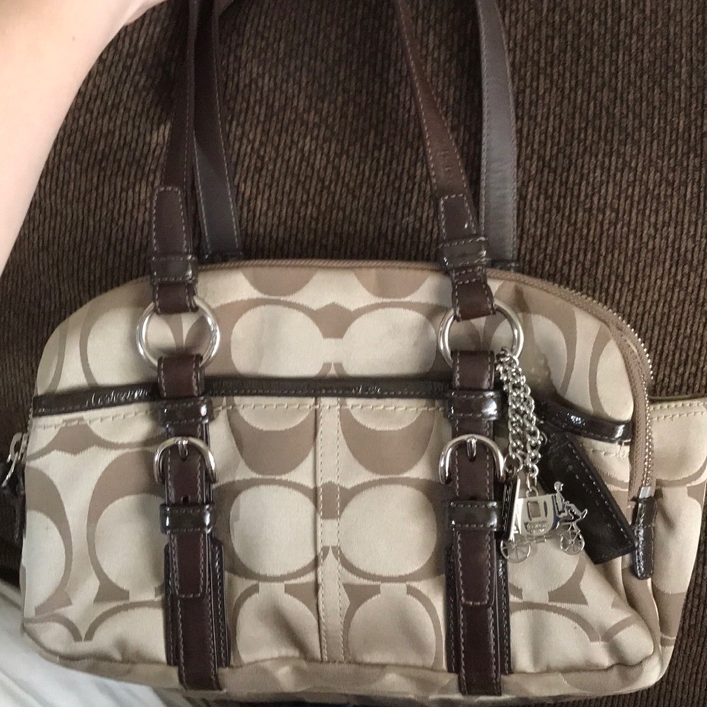 Beige coach bag with dark brown trim and handles